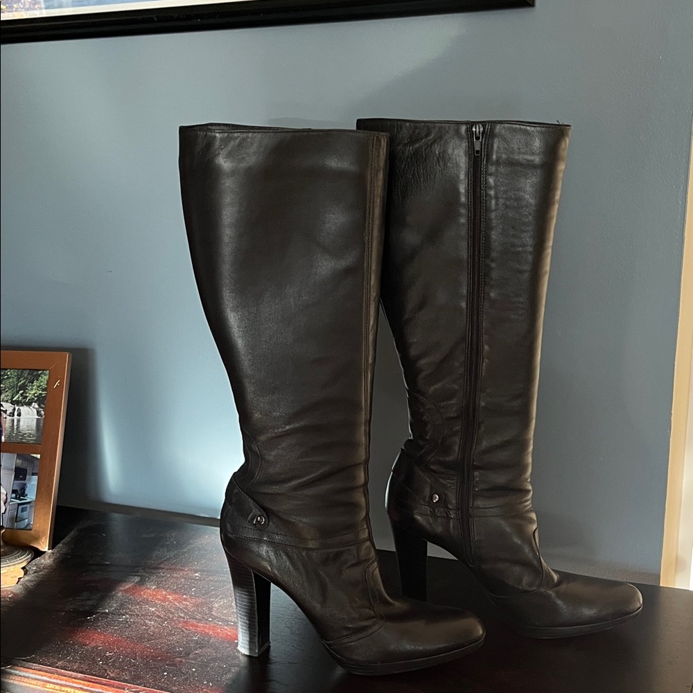 Tall black leather high heeled boots.